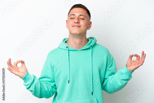 Young brazilian man isolated on white background in zen pose