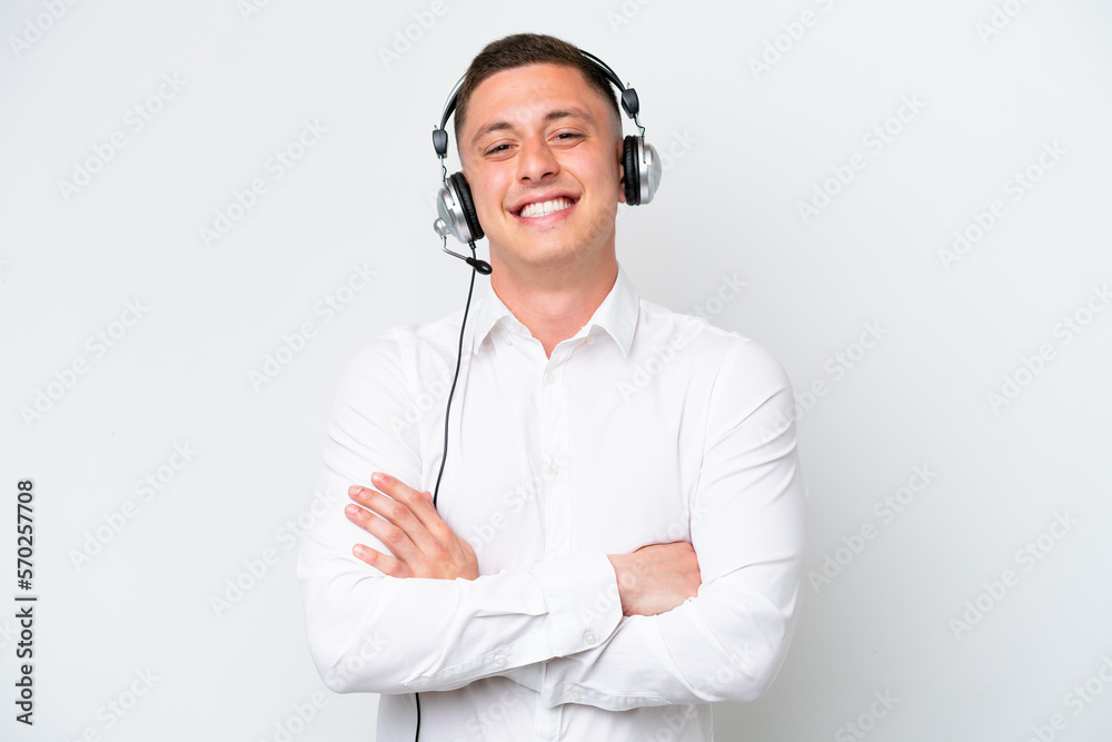 Telemarketer Brazilian man working with a headset isolated on white background keeping the arms crossed in frontal position Telemarketer Brazilian man working with a headset isolated on white background keeping the arms crossed in frontal position