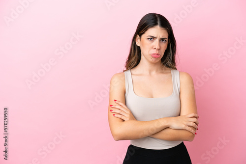 Young Italian woman isolated on pink background feeling upset