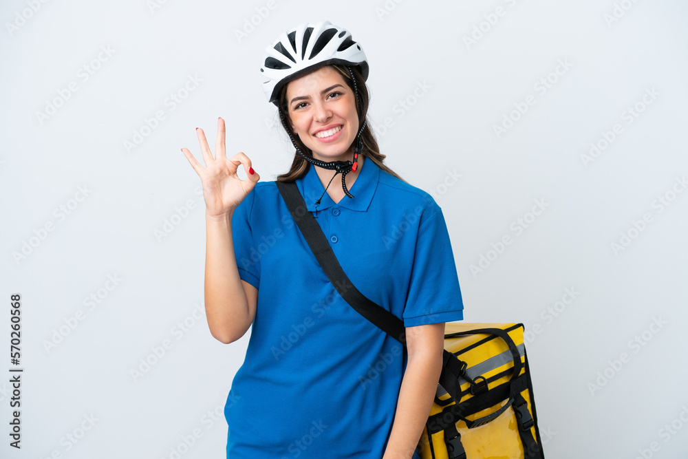 Young delivery woman with thermal backpack isolated on white background showing ok sign with fingers Young delivery woman with thermal backpack isolated on white background showing ok sign with fingers