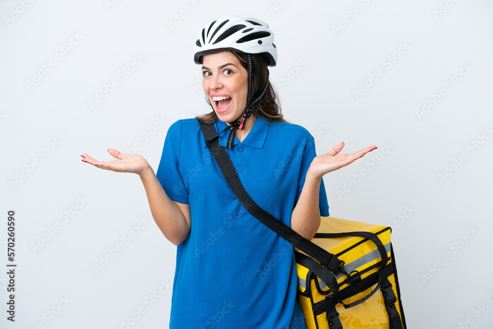 Young delivery woman with thermal backpack isolated on white background with shocked facial expression Young delivery woman with thermal backpack isolated on white background with shocked facial expression