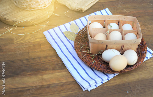 Organic raw chicken eggs in natural egg box on an old style photo