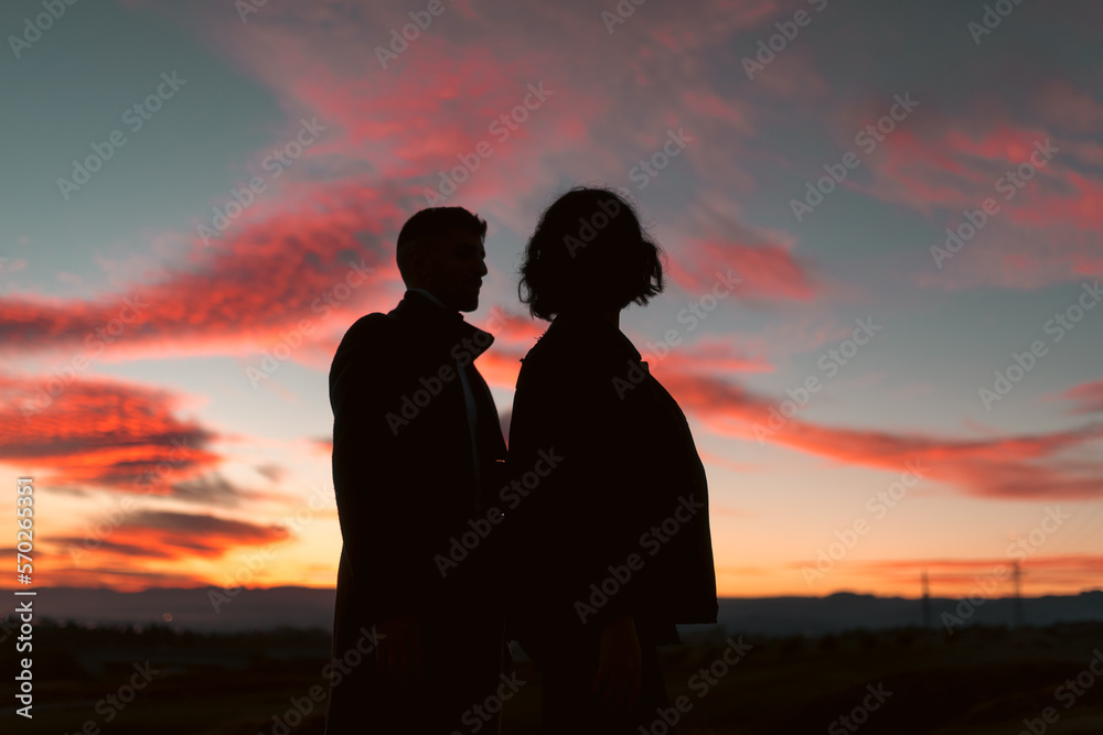 Couple silhouette under stunning sunset
