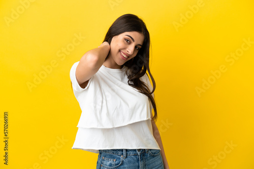 Young caucasian woman isolated on yellow background laughing