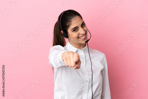 Obraz na płótnie Young telemarketer over isolated background pointing front with happy expression