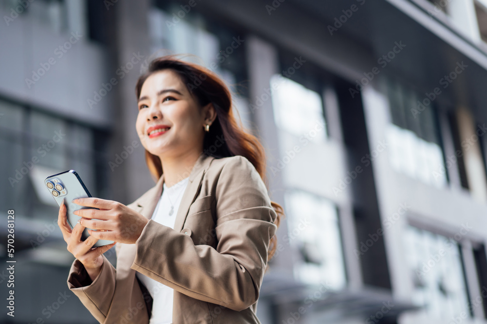 Business woman talking on mobile phone and smiling, Happy business woman, business woman with mobile phone in hand looking at camera, Image of pretty smiling woman in fashion