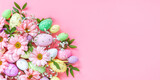 Colorful eggs with flowers on a pink background. Easter card with space for text. Spring banner
