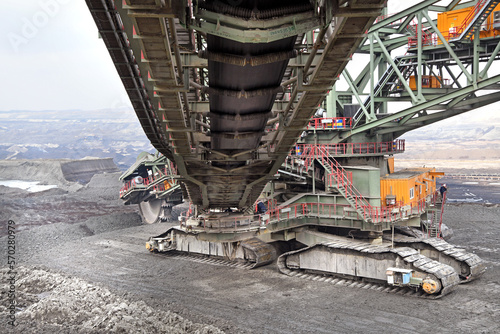 Bucket-wheel excavator during excavation at the surface mine. Huge excavator on open pit mine.