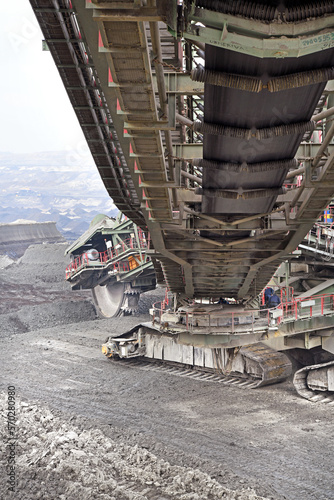 Bucket-wheel excavator during excavation at the surface mine. Huge excavator on open pit mine.