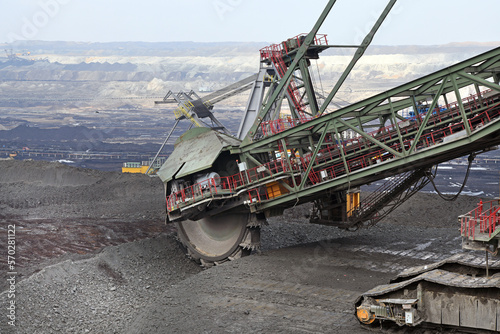 Bucket-wheel excavator during excavation at the surface mine. Huge excavator on open pit mine.