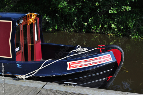 Foto Close Up of Bow of Narrow Boat on Calm Waters of Industrial Canal