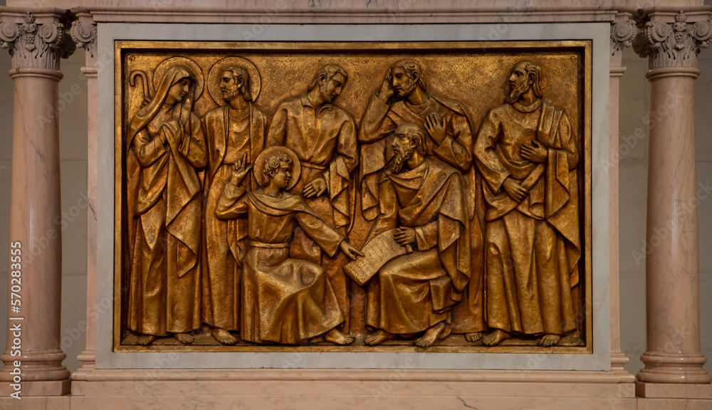 A close-up of a bronze bas-relief representing the child Jesus in the church, in the Fatima Basilica - Portugal