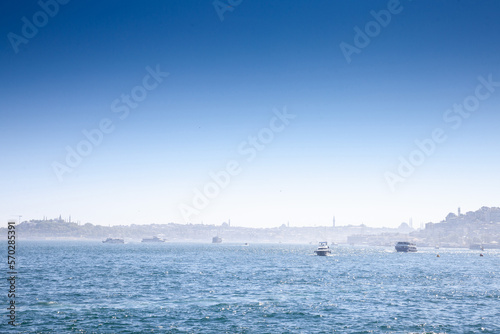 Selective blur on boats, yachts, ferries and shipsin Istanbul, touring the Bosphorus straight and the marmara sea in summer with a panorama over the European side of the city of Istanbul, Turkey.. photo