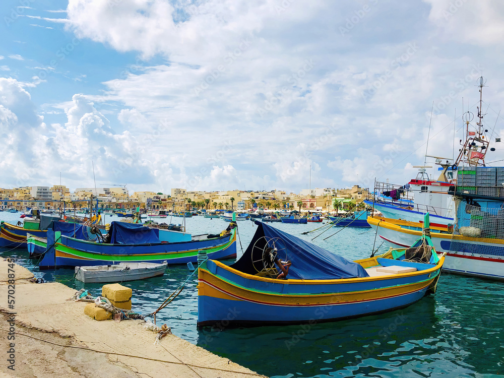 Colorful boats moored in the fishing harbor of Malta Marsaxlokk