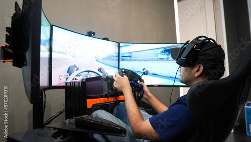 professional gamer playing online car racing photo