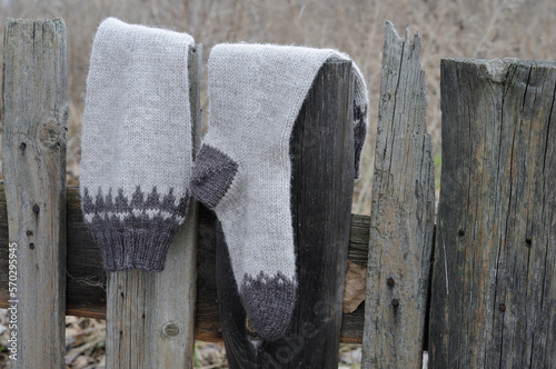 Knitted high socks with a pattern on the fence.  Front view.