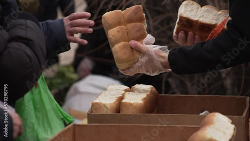 Volunteers distribute free bread to refugees