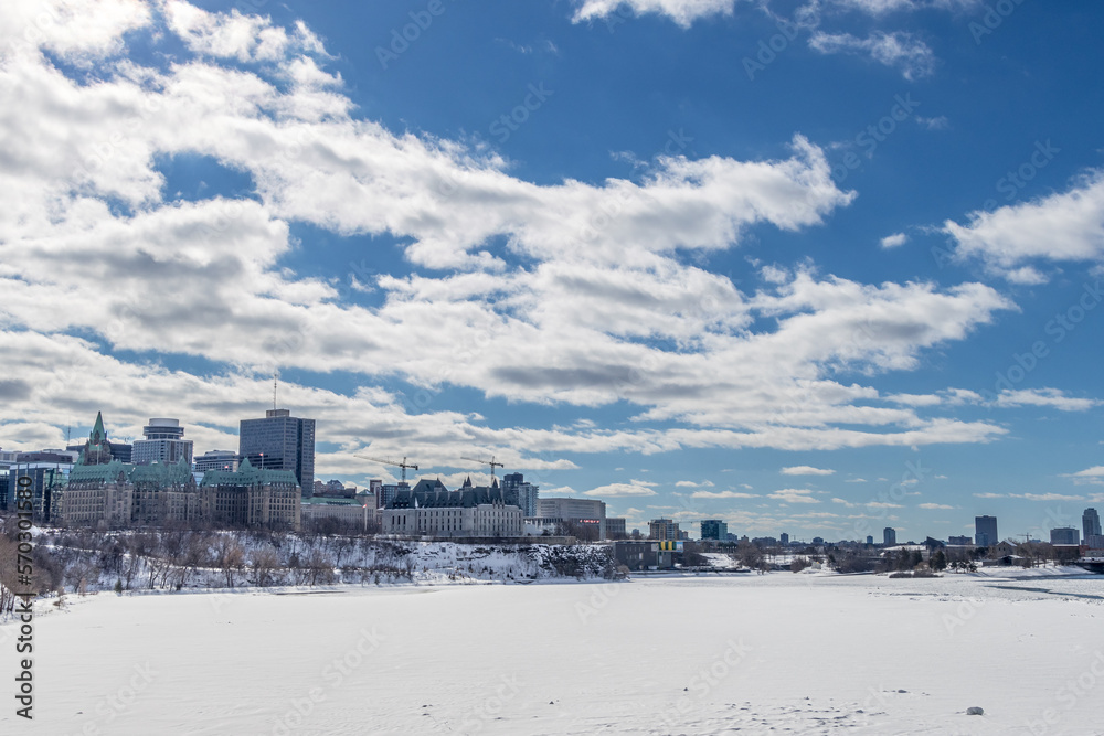 Having a walk through the Majors Hill Park in downtown Ottawa Canada with view to the historical buildings of the Canadian parliament and its surroundings at a cold but sunny day in winter.