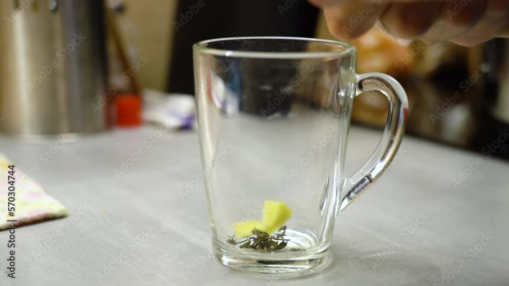 Ginger is cut into pieces and dropped into a glass to make green tea. Ginger is cut into pieces and dropped into a glass to make green tea.