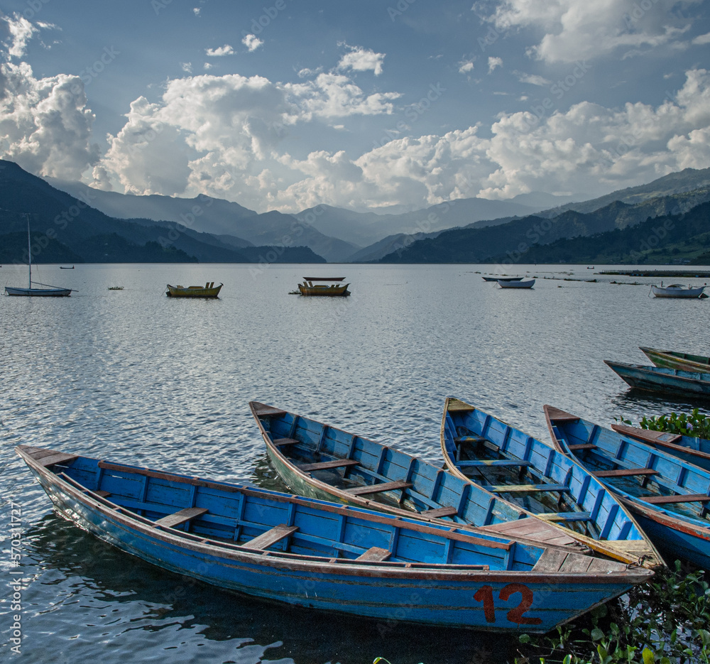 Boats on Phewa Lake at sunset, Pokhara, Nepal