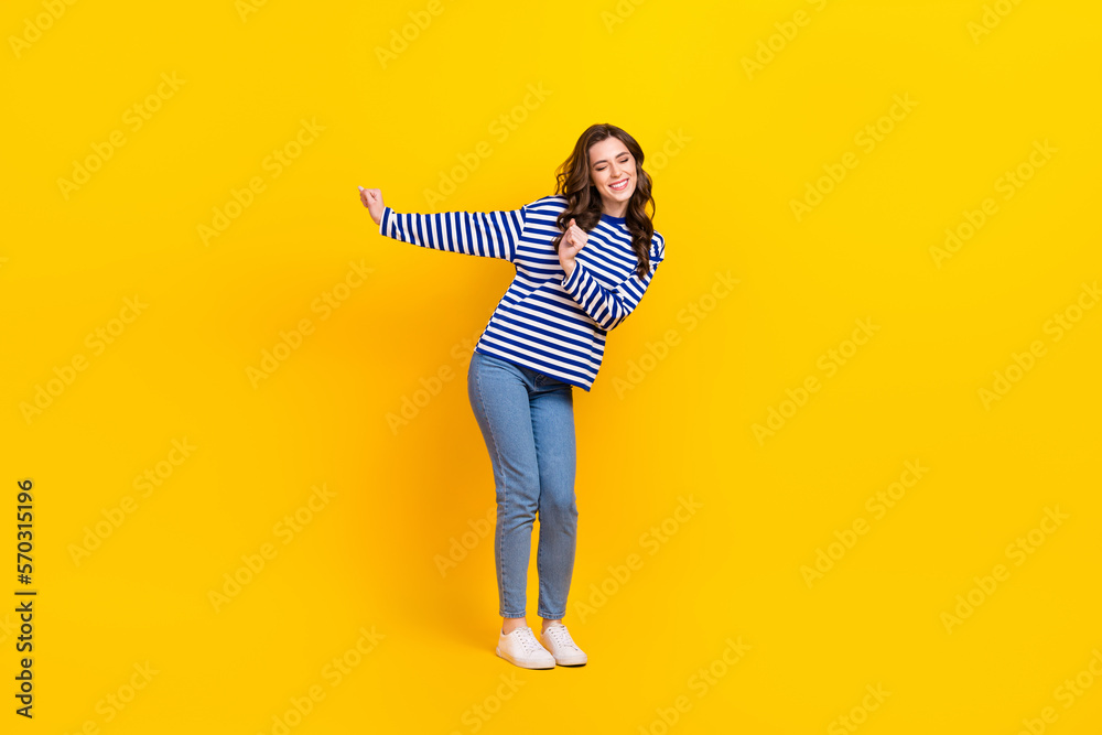 Full body portrait of satisfied glad lady have good mood enjoy dancing isolated on yellow color background