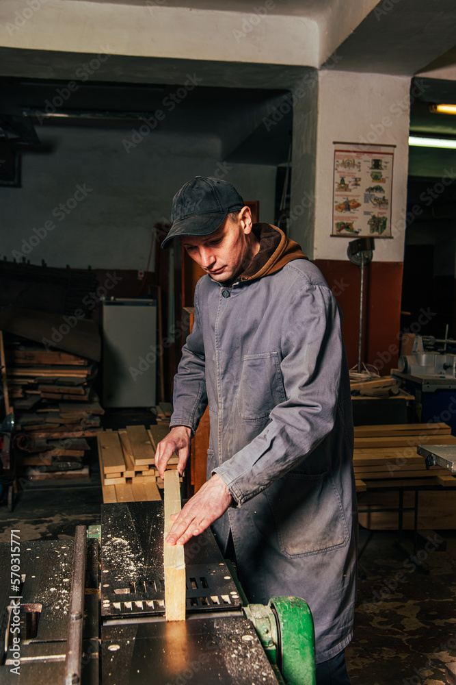 Work on woodworking machines and saws in a furniture workshop