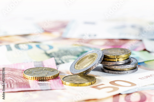 Money. Some euro coins on blurry banknotes. Economy concept for currency, business, home finance and inflation, copy space, selected focus