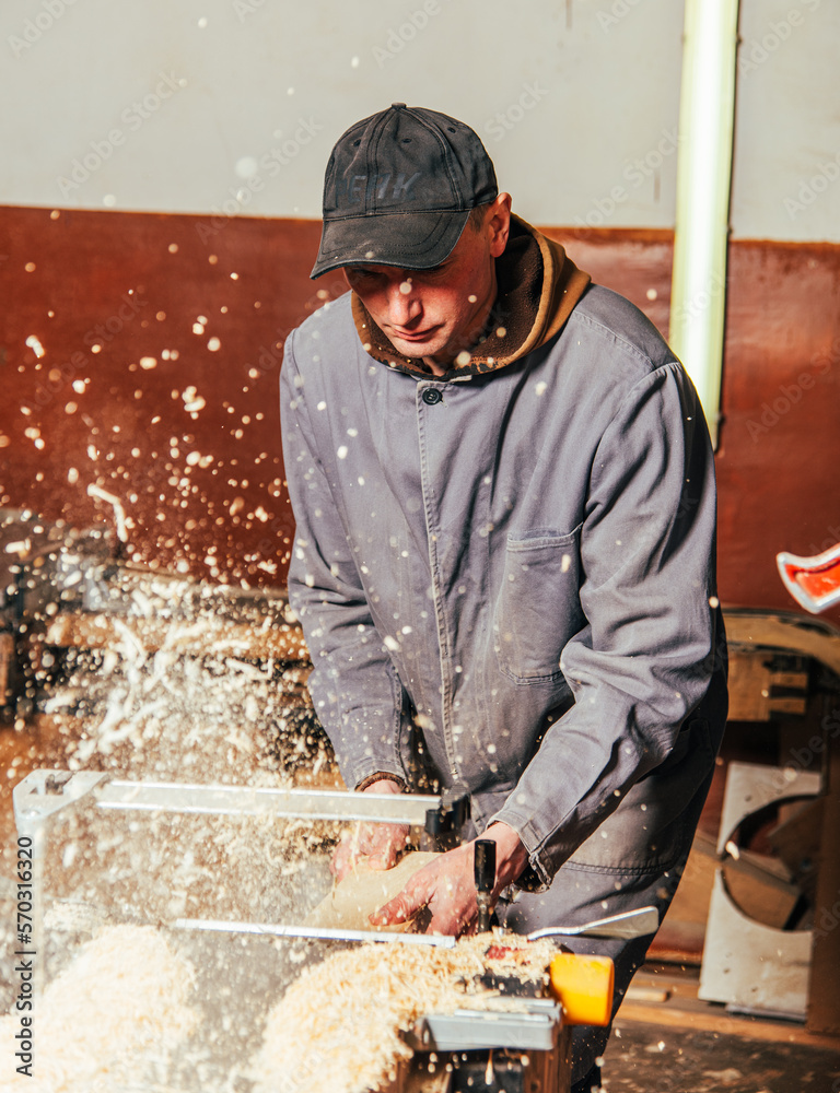Work on woodworking machines and saws in a furniture workshop Work on woodworking machines and saws in a furniture workshop