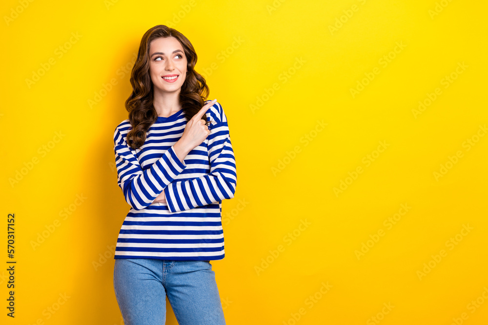Photo of cheerful dreamy cute woman direct finger empty space advertising looking opening new winter season sale isolated on yellow color background Photo of cheerful dreamy cute woman direct finger empty space advertising looking opening new winter season sale isolated on yellow color background