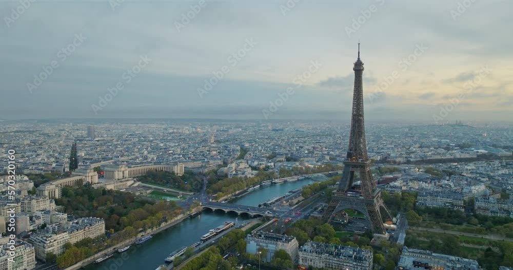 Beautiful view of famous Eiffel Tower in France with magical morning cloud and fog. Wide establishing aerial drone fly over seine river in paris city center, best travel destination landmark in Europe Beautiful view of famous Eiffel Tower in France with magical morning cloud and fog. Wide establishing aerial drone fly over seine river in paris city center, best travel destination landmark in Europe