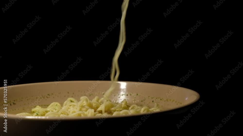 picks up noodles with a fork picks up noodles with a fork