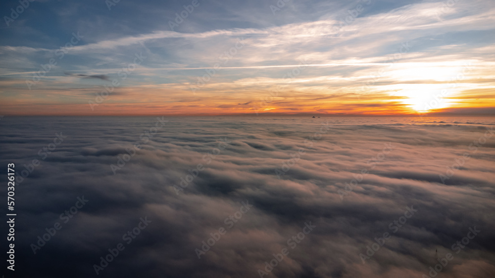 Beautiful sunset with an inversion that looks like a flowing sea. Sunset in autumn under Jested. Photographed by drone