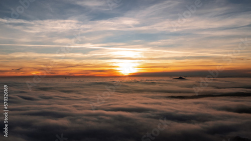 Beautiful sunset with an inversion that looks like a flowing sea. Sunset in autumn under Jested. Photographed by drone © Jan Ptáček