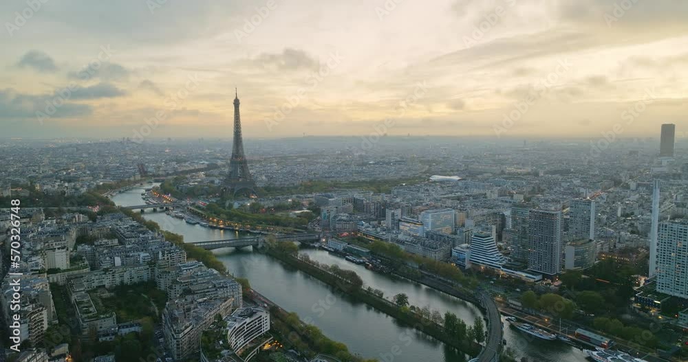 Beautiful view of famous Eiffel Tower in France with magical morning cloud and fog. Wide establishing aerial drone fly over seine river in paris city center, best travel destination landmark in Europe Beautiful view of famous Eiffel Tower in France with magical morning cloud and fog. Wide establishing aerial drone fly over seine river in paris city center, best travel destination landmark in Europe