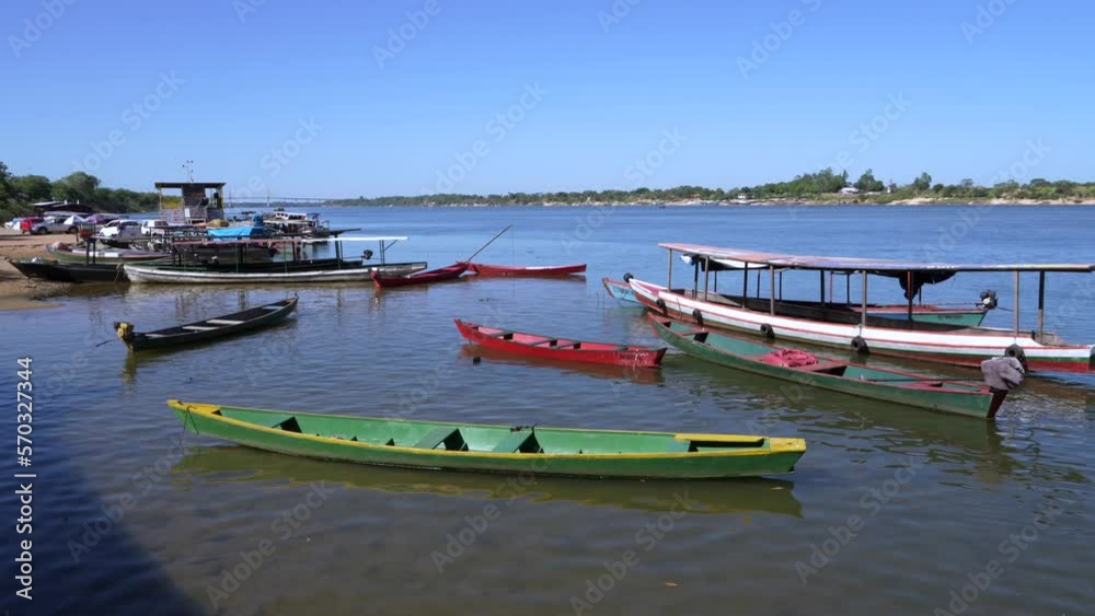 View of small colorful wooden boats on the Tocantins River on a sunny summer day in the Amazon rainforest. Maranhao, Brazil. Vessel, navigation, travel, tourism concept. View of small colorful wooden boats on the Tocantins River on a sunny summer day in the Amazon rainforest. Maranhao, Brazil. Vessel, navigation, travel, tourism concept.