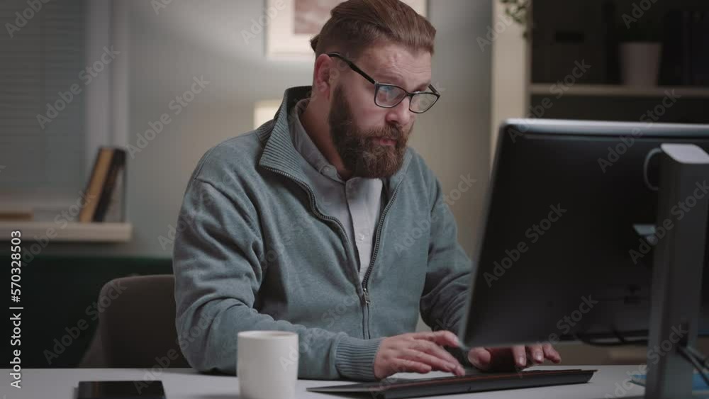 Mature bearded man suffering heartache while working on computer, heart desease concept Mature bearded man suffering heartache while working on computer, heart desease concept