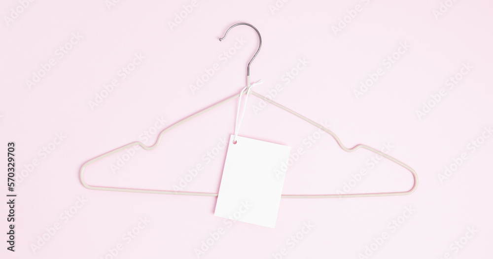 Creative flat lay hanger with white paper label pink background. Clothing tag, label blank mockup template. Sale discount store promo shopping concept. Top view. Copy space Creative flat lay hanger with white paper label pink background. Clothing tag, label blank mockup template. Sale discount store promo shopping concept. Top view. Copy space
