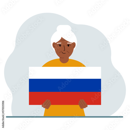 A woman holds a Russian flag in his hands. The concept of demonstration, national holiday or patriotism. Nationality.