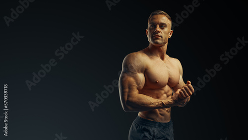 Shirtless bodybuilder, perfect male torso. Copy free space. 