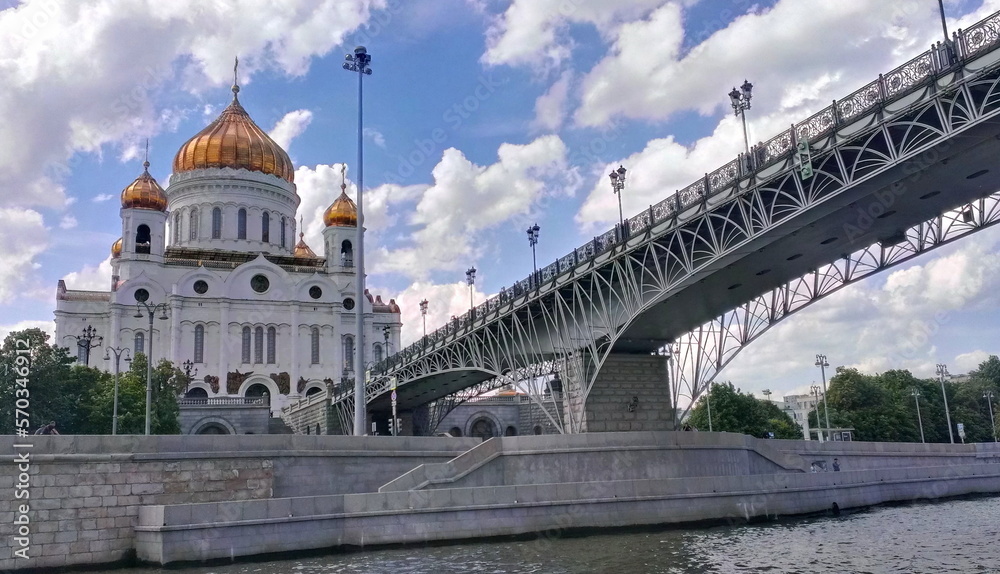 Moscow , Russia – 06 14 2022: Christ the Savior Cathedral and the Patriarchal Bridge on Moscow river at summer day