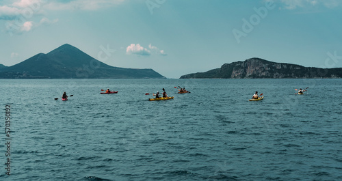 canoe trip in the sea , mountains shore, tourist group making water sports © Ela