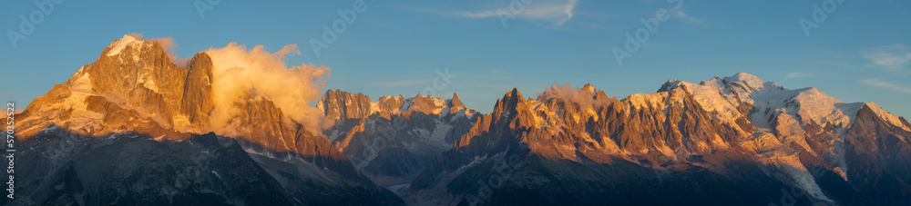 The panorama of Mont Blanc massif  Les Aiguilles towers, Grand Jorasses and Aiguille du Verte in the sunset light.