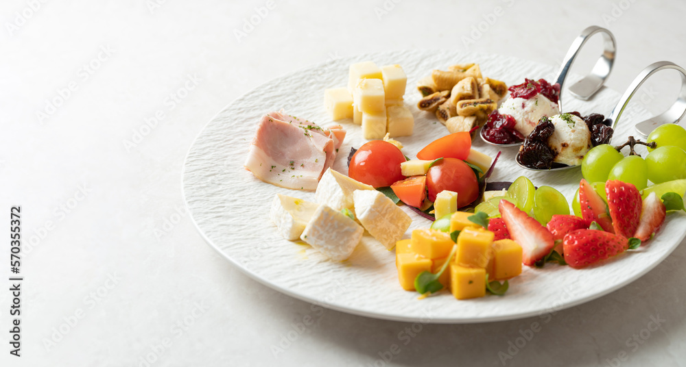 Various cheeses, fruits and raw ham Various cheeses, fruits and raw ham
