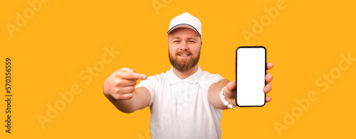 Banner size of a delivery man wearing white and pointing at the phone screen over yellow background.