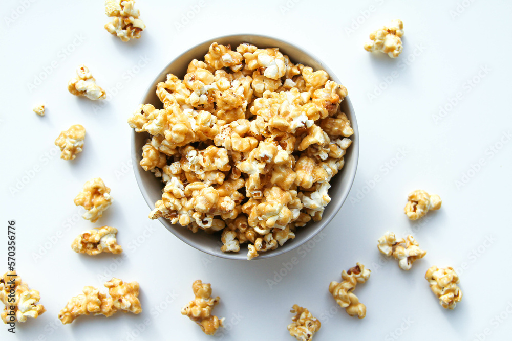 Caramel popcorn in a bowl, on a white background Caramel popcorn in a bowl, on a white background