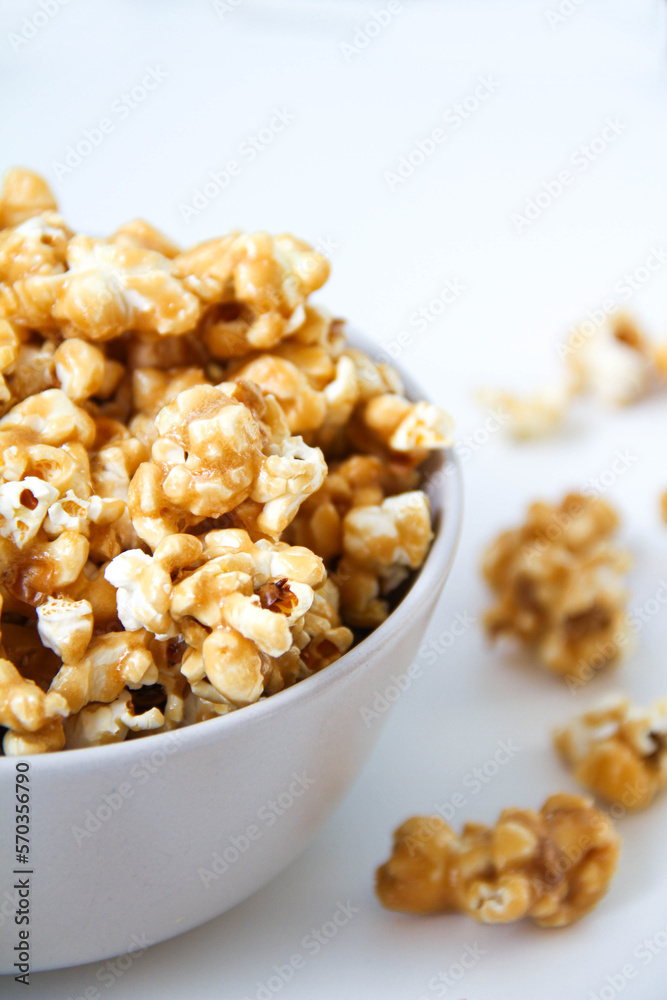 Caramel popcorn in a bowl, on a white background Caramel popcorn in a bowl, on a white background