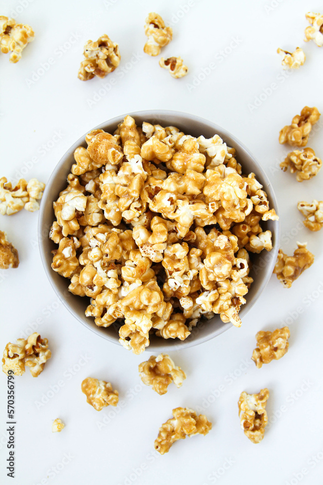 Caramel popcorn in a bowl, on a white background Caramel popcorn in a bowl, on a white background