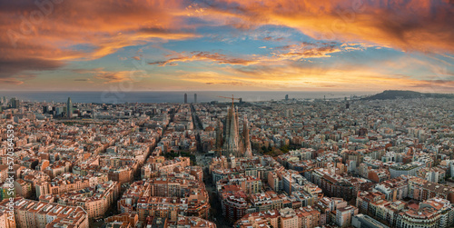 Aerial view of Barcelona City Skyline and Sagrada Familia Cathedral at sunset. Eixample residential famous urban grid. Cityscape with typical urban octagon blocks photo