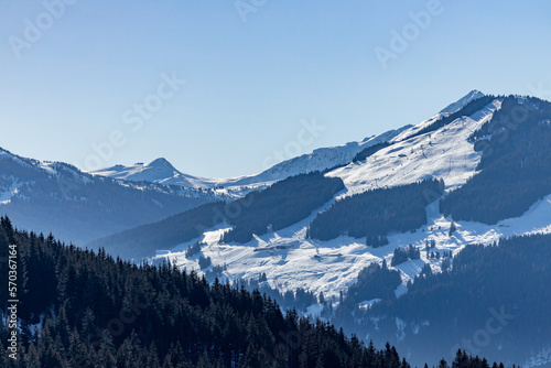 Bright sunlight over snow covered mountains in the Austrian Alps - Ski resort Ktizbühel, Tirol 