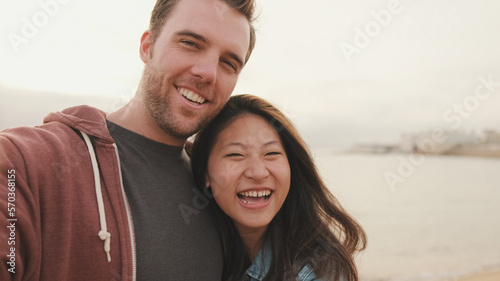 Laughing couple talking on video call